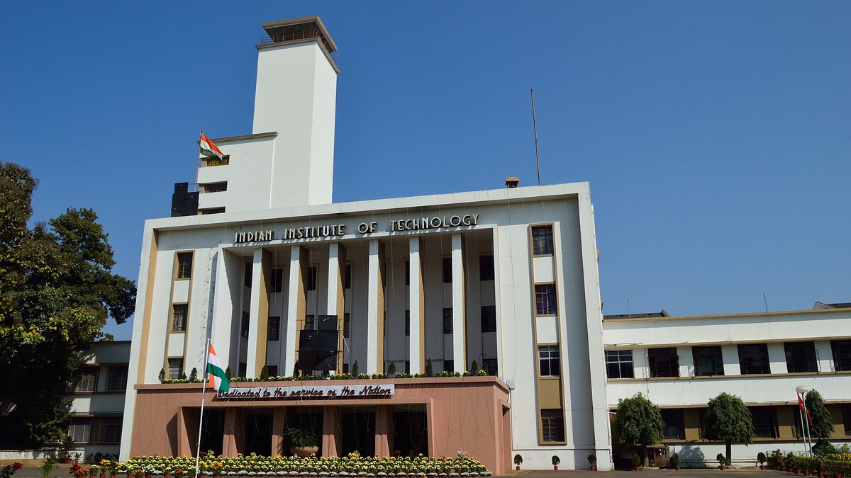 The Main Building of IIT Kharagpur, with its white tower and "Indian Institute of Technology" lettering, against a clear blue sky